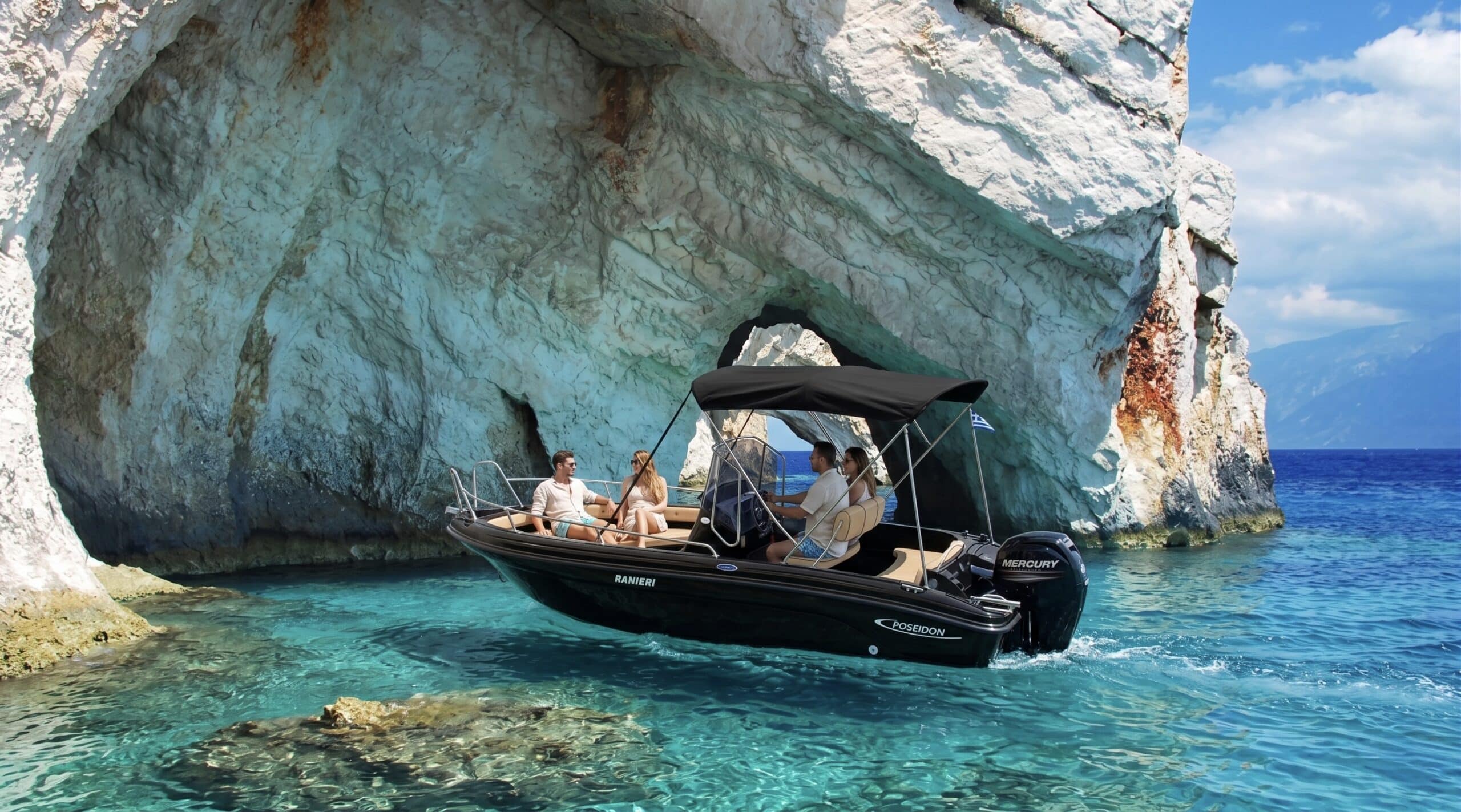 Rental boat inside the electric-blue waters of the Blue Caves, North Zakynthos