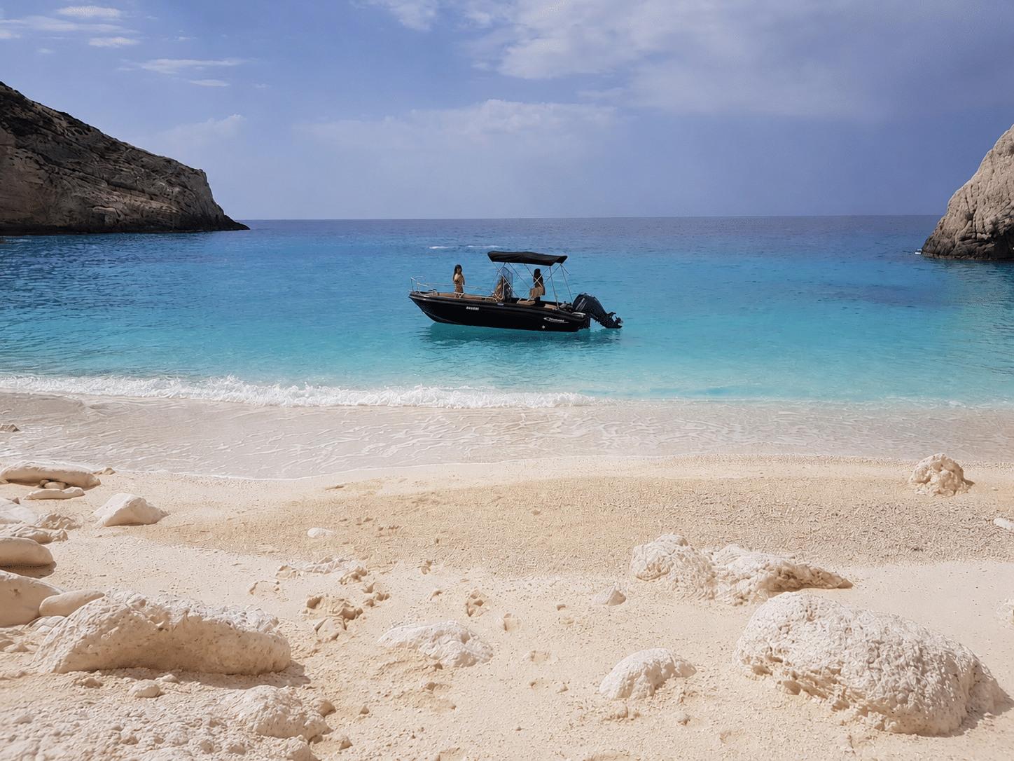 Self-drive boat anchored at the secluded White Beach, North Zakynthos