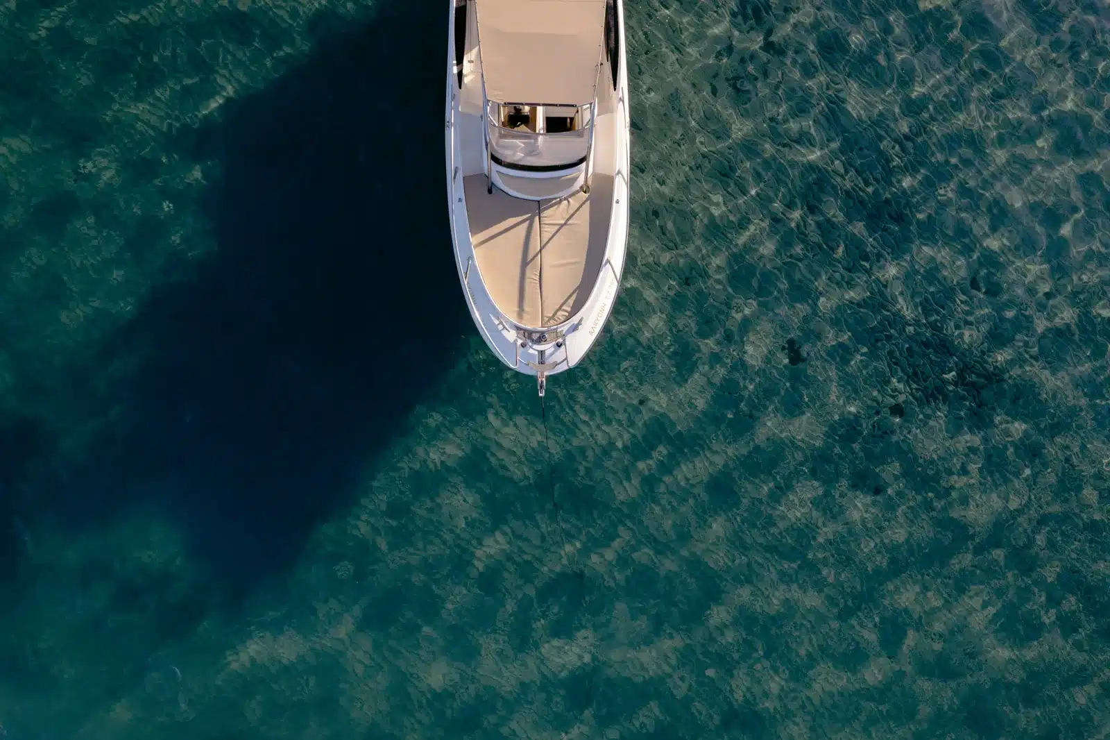 Aerial view of the featured private charter boat cruising through clear Ionian water