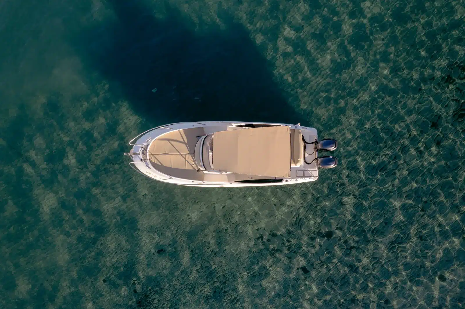 Featured private charter boat anchored over turquoise water in Zakynthos