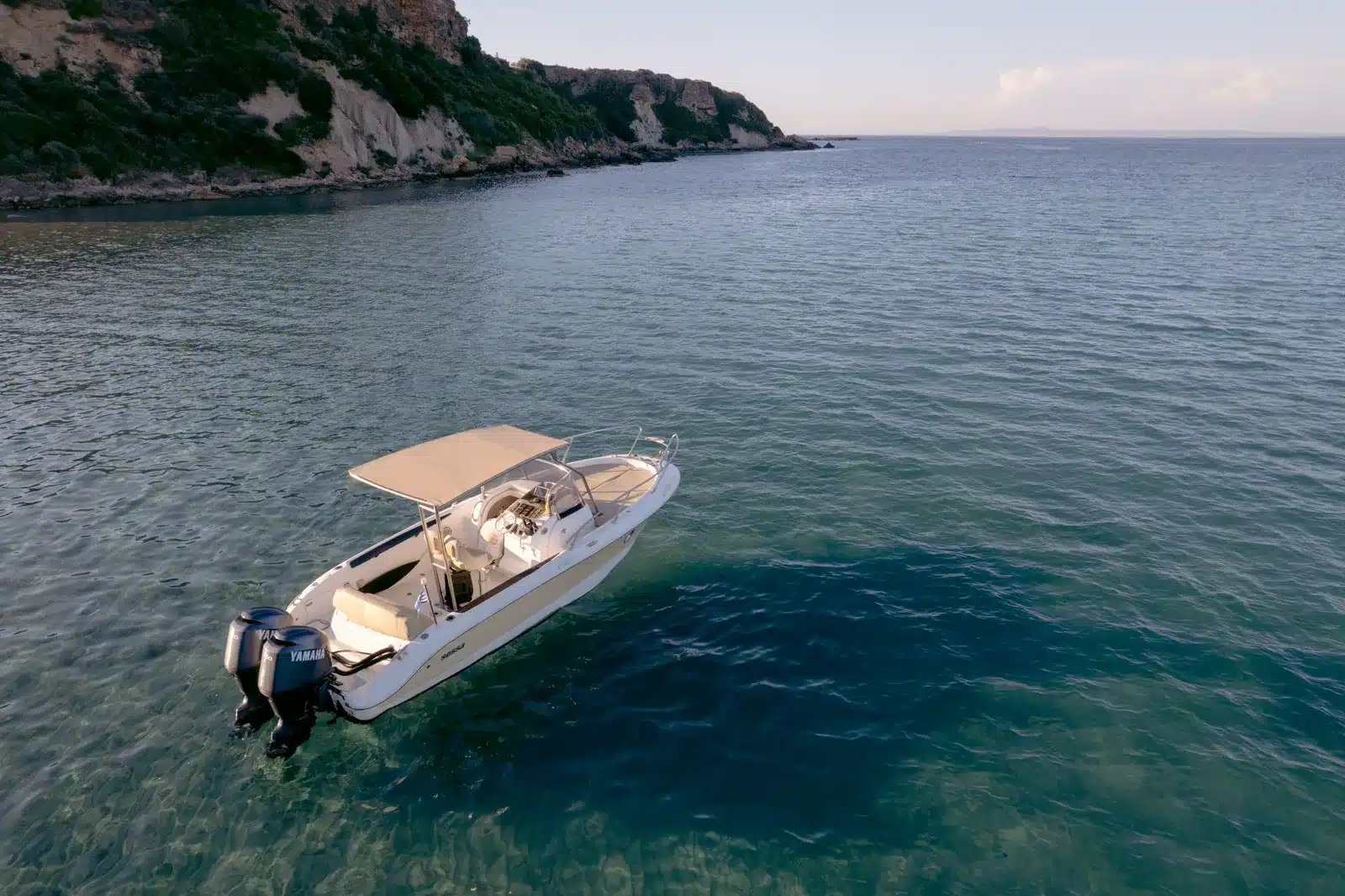 Private charter boat cruising beside the Zakynthos coastline